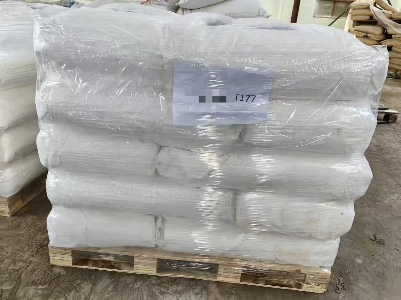 Child flying kite against bright blue sky.